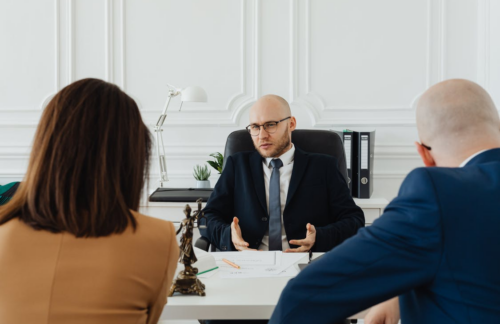 Agent talking to clients looking for high-risk auto insurance