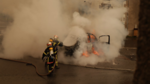 fireman putting out a burning car