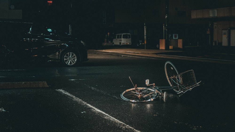 a damaged bike and car with High-Risk insurance