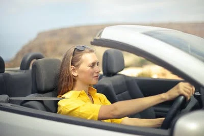 A driver wearing a seatbelt while driving 