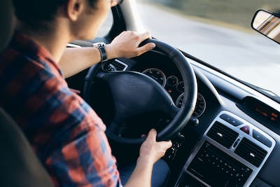 A person driving a borrowed car