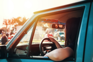 a lady driving a car