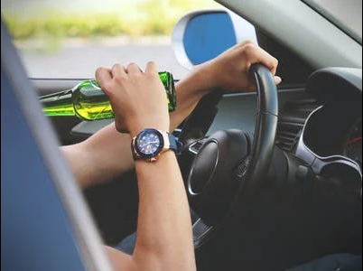 A driver drinking beer while driving