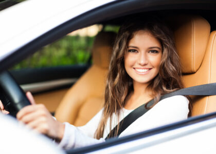 Woman with high-risk SR-22 FR-44 insurance in a car.