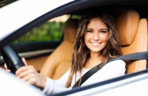 Woman with high-risk SR-22 FR-44 insurance in a car.