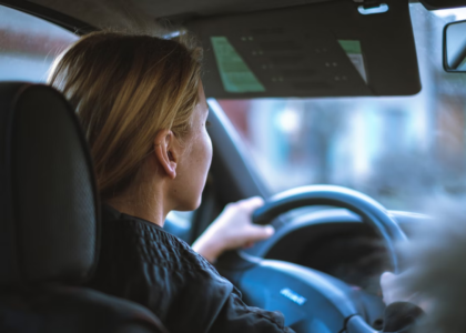 A young woman driving a car with Virginia FR-44 insurance.