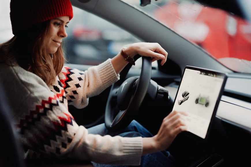 A person driving a tesla