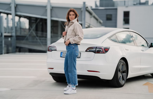 A person standing next to a car