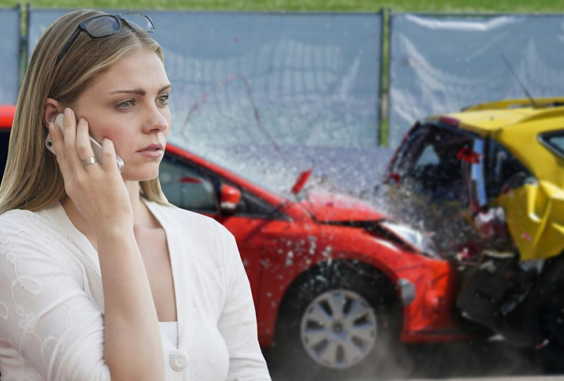 Woman on phone looking concerned in front of a car accident scene with a red and yellow vehicle, relating to high-risk auto insurance and SR22 coverage.