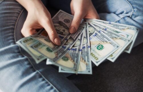 A person counting the money needed to pay fines for DUI in Florida.