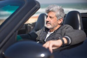A man driving along the coast after paying fines for DUI in Florida.