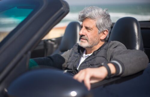A man driving along the coast after paying fines for DUI in Florida.