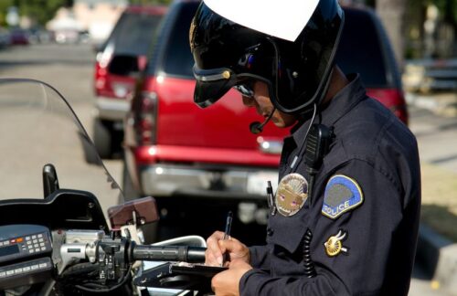 A motorcycle cop is writing a ticket to a driver for violating the Tennessee hands-free driving law.
