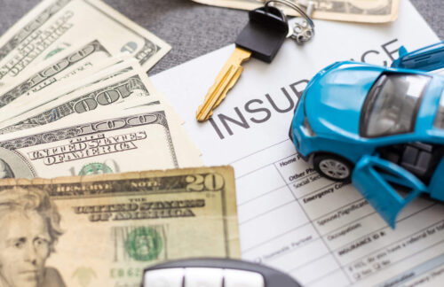 Car insurance form with car key, toy car, and cash currency, symbolizing non-owner SR22 insurance costs.
